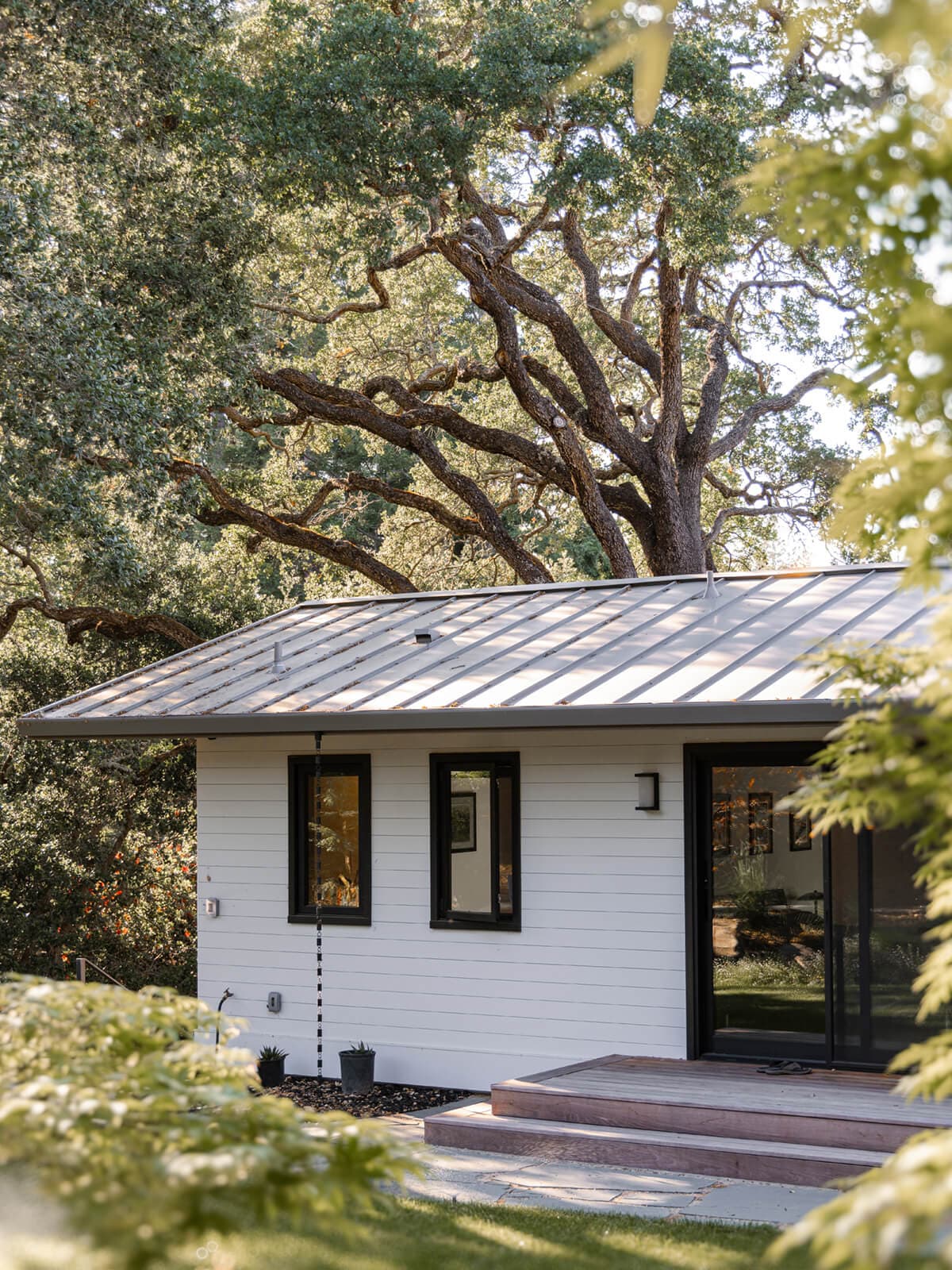 Garage with a standing seam roof and painted siding