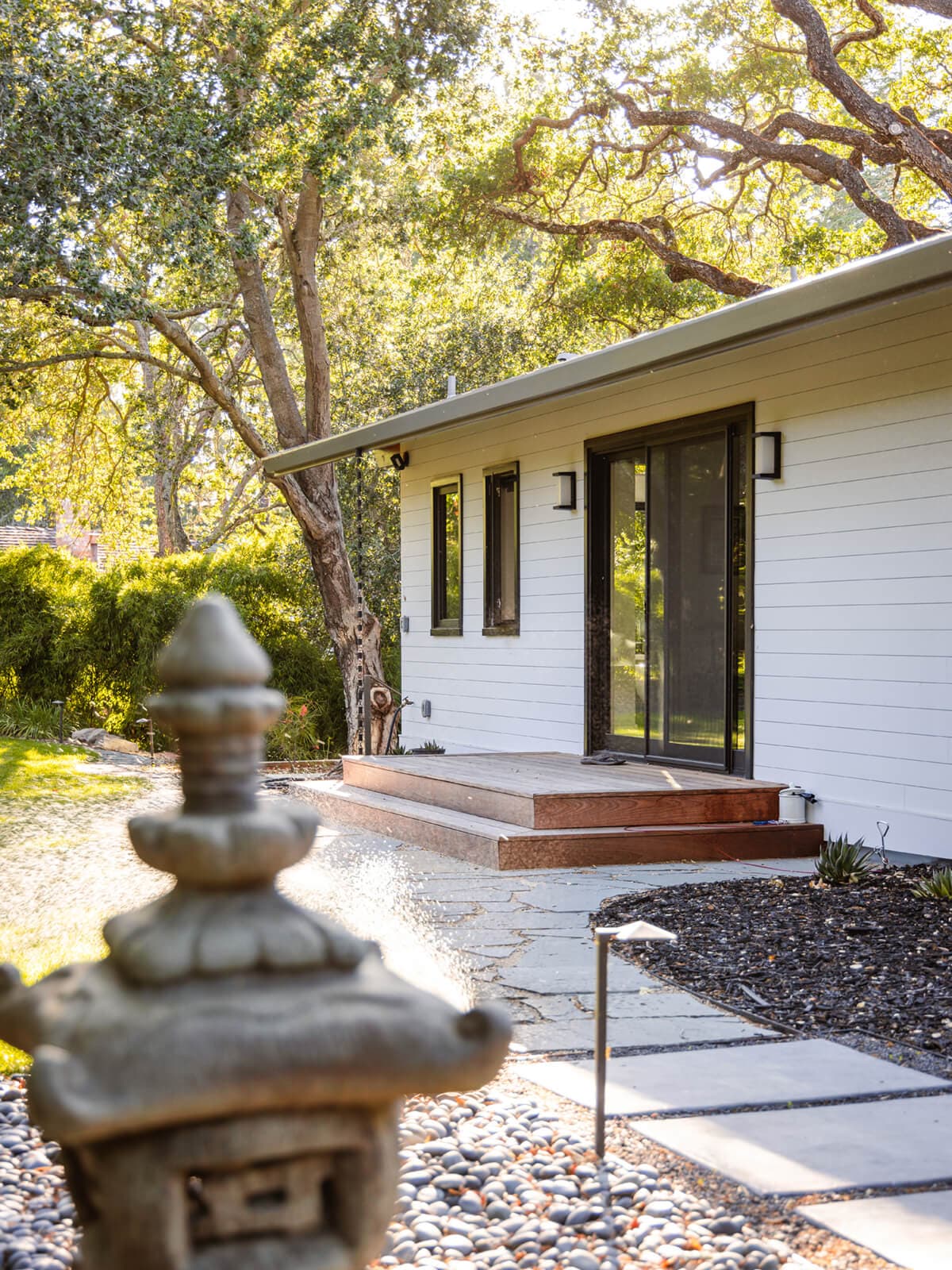 Sliding door and wood steps at the side of the house