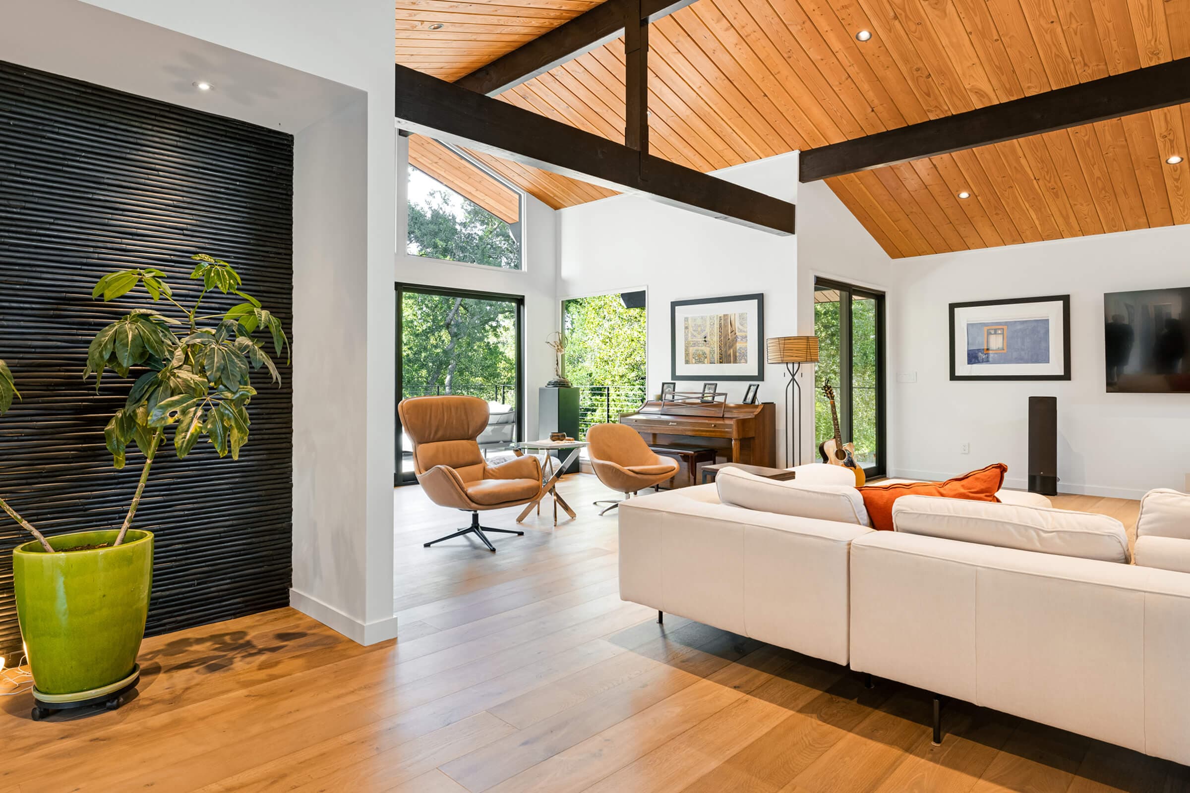 Entry opening to the living room under a wood ceiling and dark beams